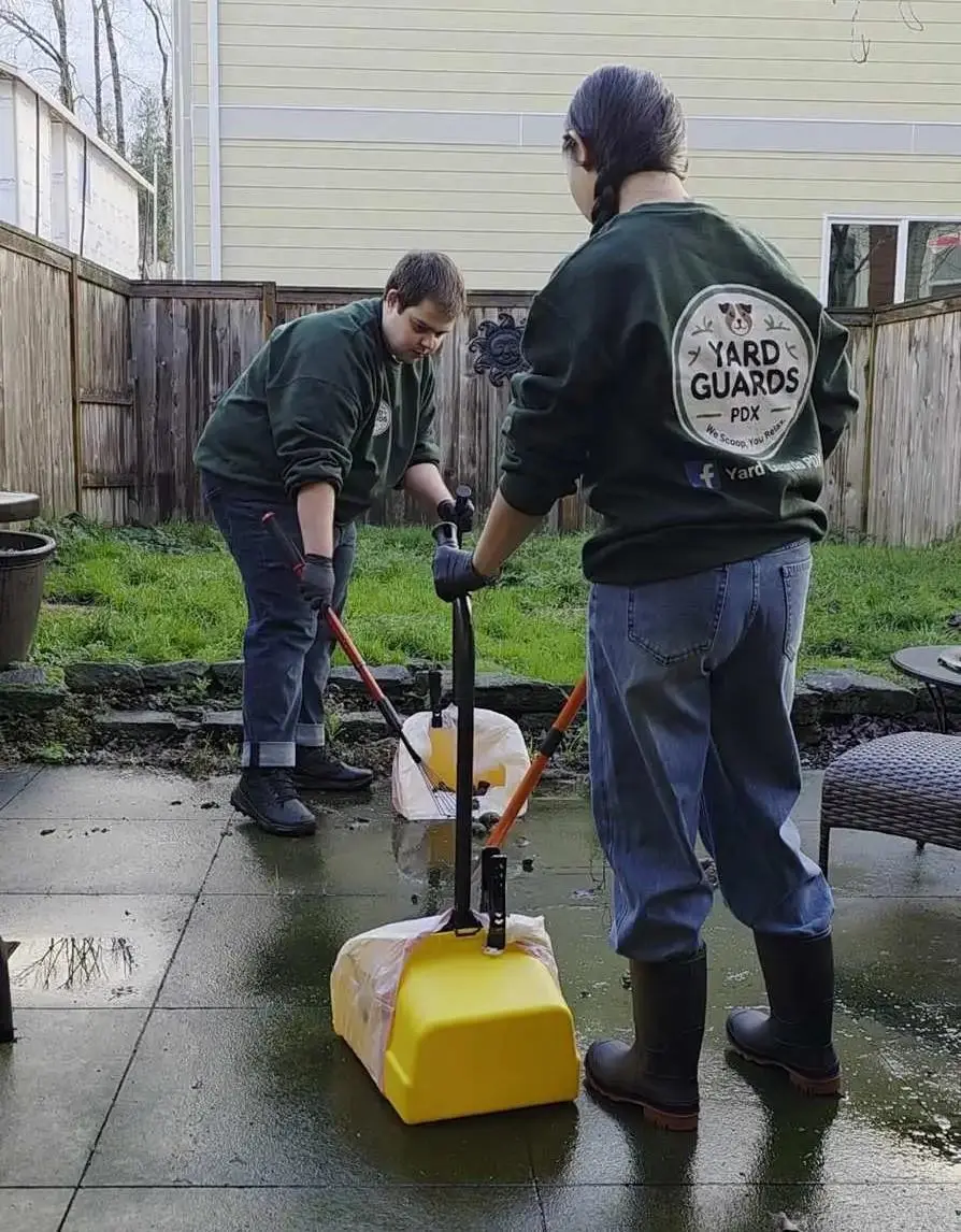 Professional Yard Guards PDX team member providing expert pet waste removal service